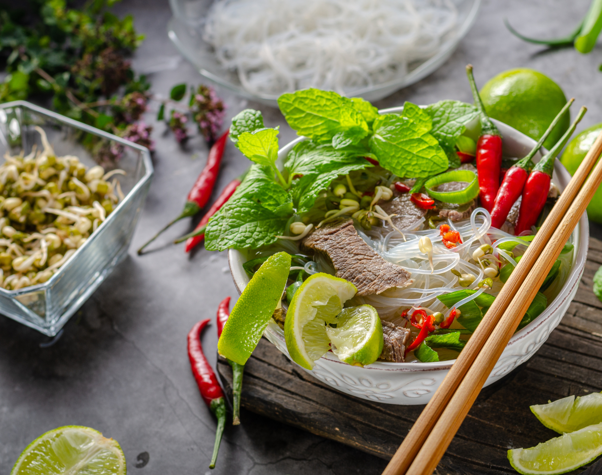 Traditional,Vietnamese,Soup,With,Chilli,,Noodles,,Fresh,Herbs,And,Beef