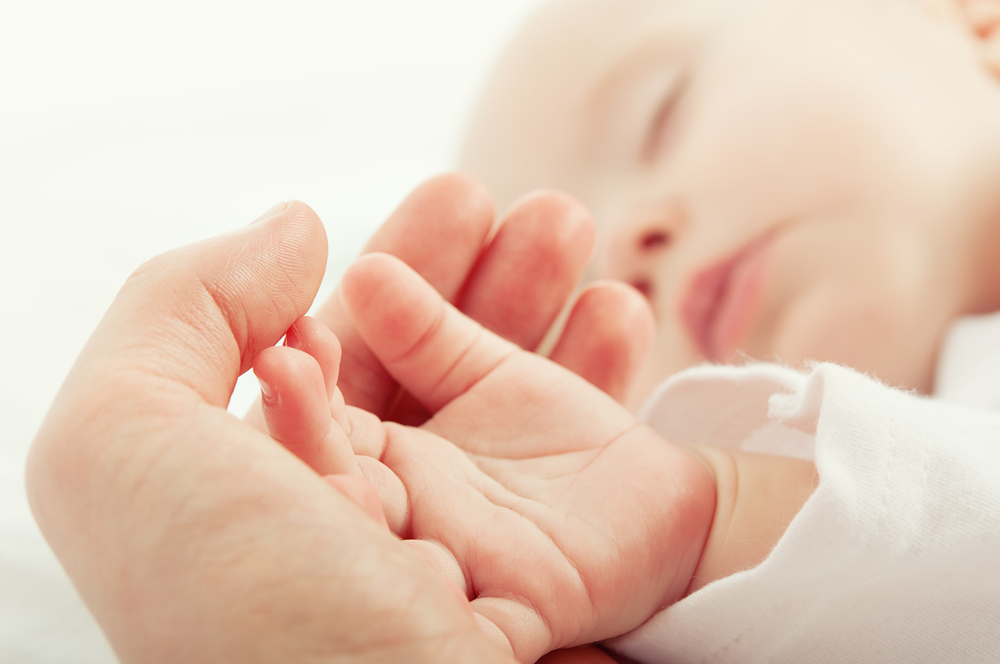 Hand,The,Sleeping,Baby,In,The,Hand,Of,Mother,Close-up