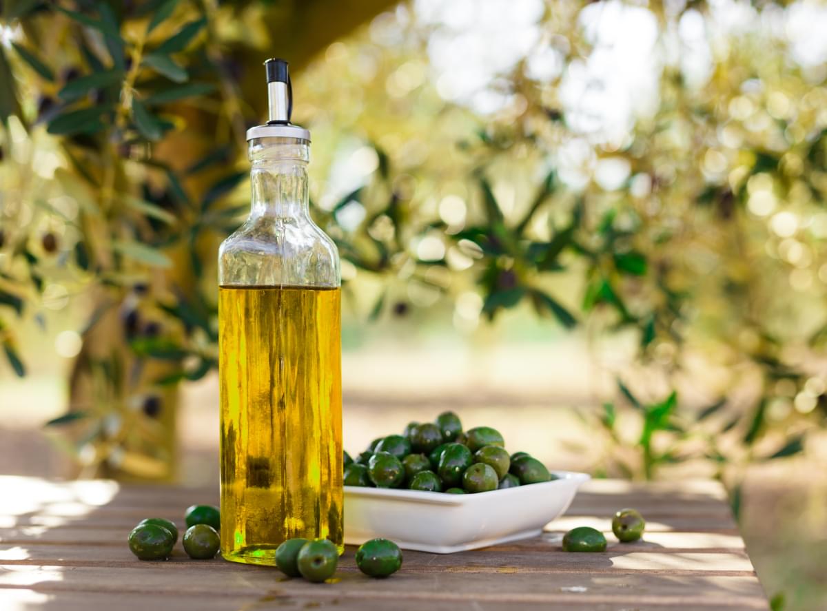 Still,Life,With,Green,Olives,And,Oil,On,Table,In